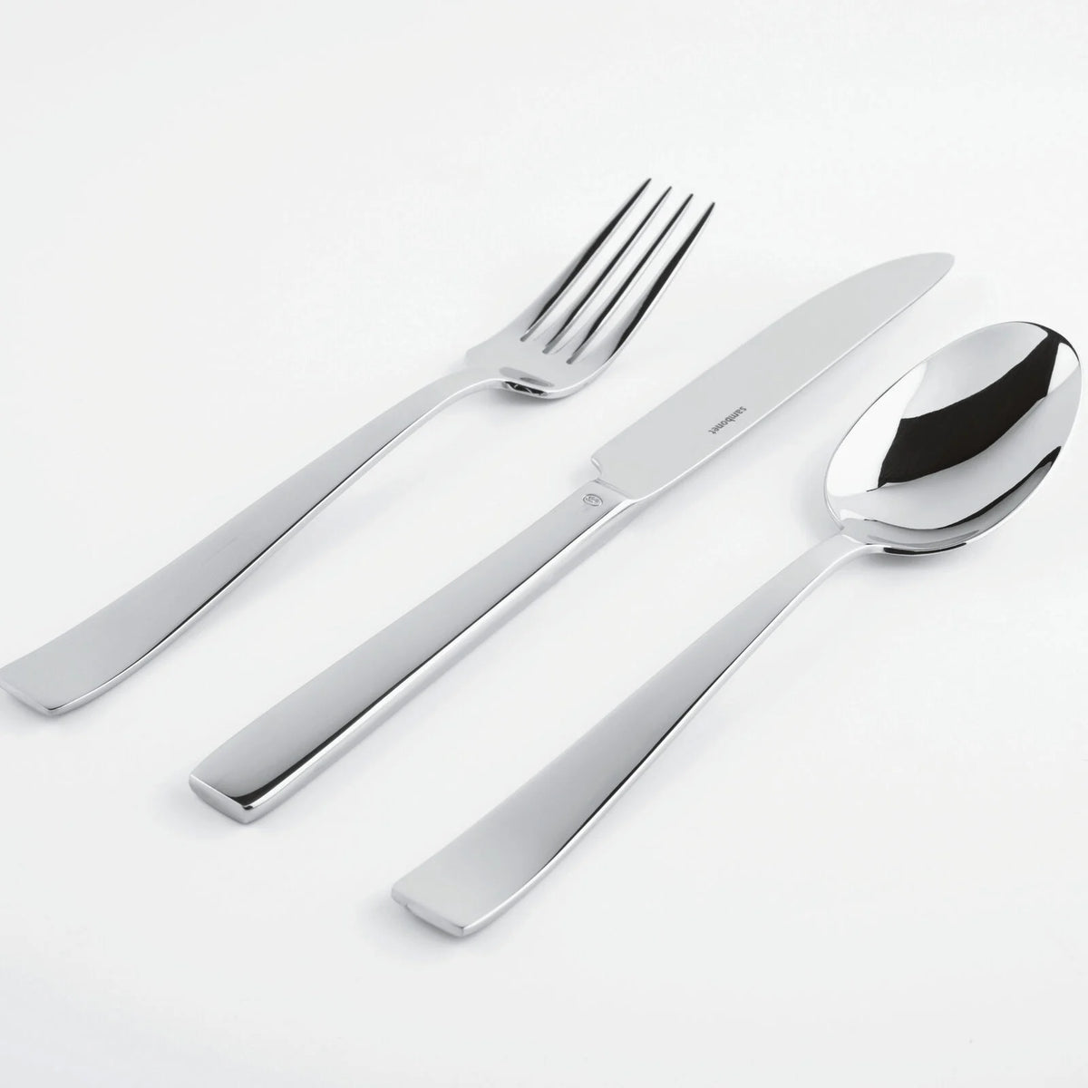 The Sambonet Flat Flatware 5 Piece Setting in stainless steel, featuring a mirror-effect finish, is arranged side by side on a white background.