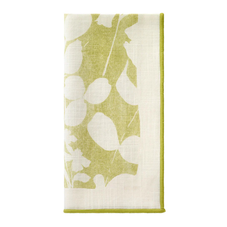 The Bodrum Fleur de Lin Napkin s/4 - Green features a folded white cotton design with green leaf and floral prints and green edging, ideal for coordinating with matching floral linens or a stylish table runner.