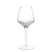 The Saint-Louis Folia Stemware is a clear, elegant crystal wine glass with a long stem and hand-cut facets on the lower bowl, shown on a plain white background.