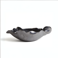The Free Form Graphite Bowl by Global Views/Surya features a matte graphite, dark metallic finish with an irregular wavy rim and organic shape, crafted from Portuguese ceramic and displayed against a plain white background.