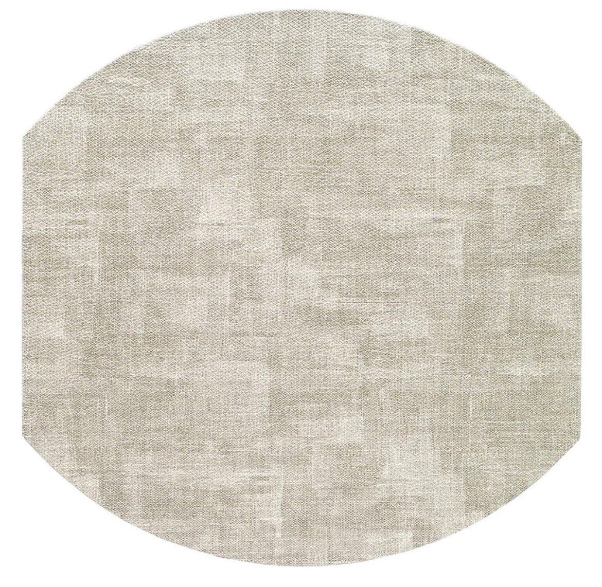 The Bodrum New Luster Elliptic Placemat in Granite (Set of 4) features a round, light beige design with a subtle textured pattern and angled edges, shown against a white background.