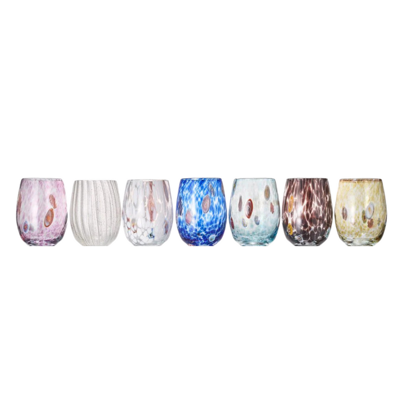 The Kim Seybert Gala Stemless Tumbler Set 4 includes four colorful, Murano Glass-inspired tumblers with unique marbled and speckled patterns in pink, white, blue, and brown, arranged on a white background.