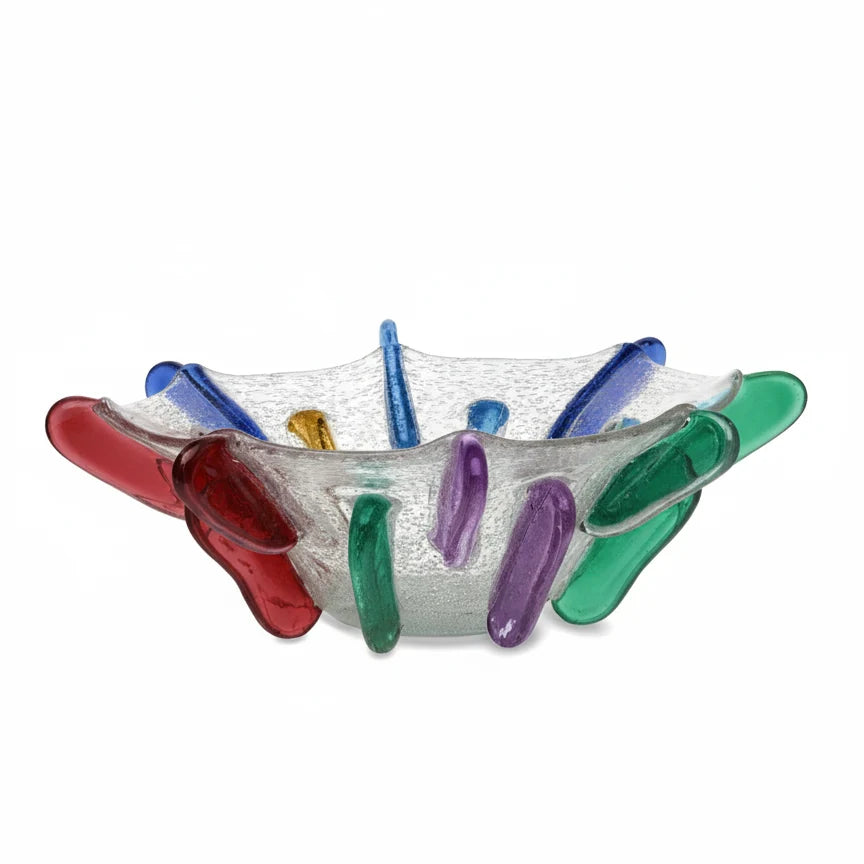 Introducing the Yakush Japanese Winter Bowl - Neon: a clear, textured recycled blown glass bowl adorned with vibrant neon red, green, blue, and yellow curved glass accents around the outer rim.