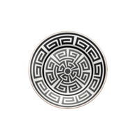 The Labirinto Dinnerware Nero by Ginori 1735 features a round porcelain plate with a black and white Greek key pattern in concentric circles, inspired by Gio Ponti’s geometric style, on a crisp white background.