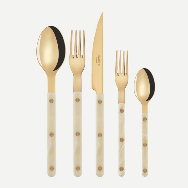The Sabre Bistrot Horn 5 Piece Place Setting features gold-colored stainless steel cutlery with ivory handles—a large spoon, large fork, knife, small fork, and small spoon—elegantly displayed on a white background.