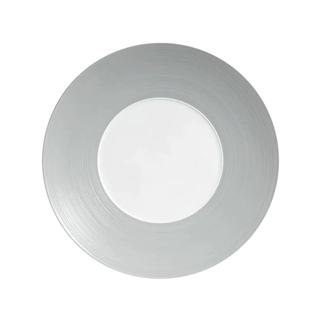A round, silver charger plate with a white center from JL Coquet, inspired by Hemisphere Dinnerware Grey and the elegance of Limoges porcelain.