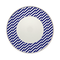 The Vista Alegre Harvard Dinnerware is a round white porcelain plate with a wide rim featuring bold blue and white diagonal stripes, evoking classic New England style. Made in Portugal.