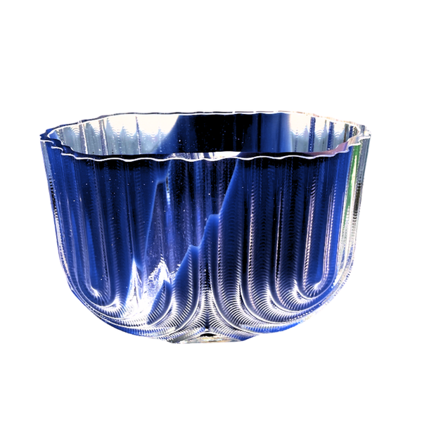 The Heater Vessel - Low - Indigo Blue Splash by Matt Kolbrener features artisan glass with vertical ridges and a wavy, scalloped rim—a striking decorative piece that beautifully reflects light for modern industrial spaces.