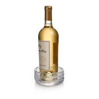 A bottle of white wine stands upright inside the Simon Pearce Echo Lake Wine Coaster, displayed on a white background.