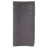 The Bodrum Riviera Napkin Set of 4 features neatly folded, rectangular dark gray linen napkins displayed against a white background.