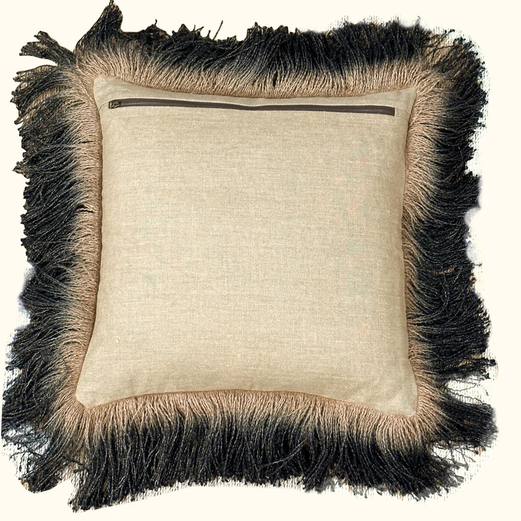 The Jute Hand Dyed Fringe Pillow Carbon by Threads Soft Goods features beige linen fabric, a back zipper, and thick two-toned light brown and black jute-like fringe around the edges.