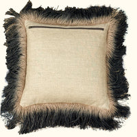 The Jute Hand Dyed Fringe Pillow Carbon by Threads Soft Goods features beige linen fabric, a back zipper, and thick two-toned light brown and black jute-like fringe around the edges.