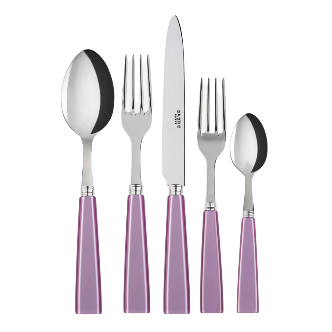 The Sabre Icone Flatware 5 Piece Setting features shiny 18/10 stainless steel heads and purple handles, including a tablespoon, dinner fork, knife, salad fork, and teaspoon—all upright on a white background.