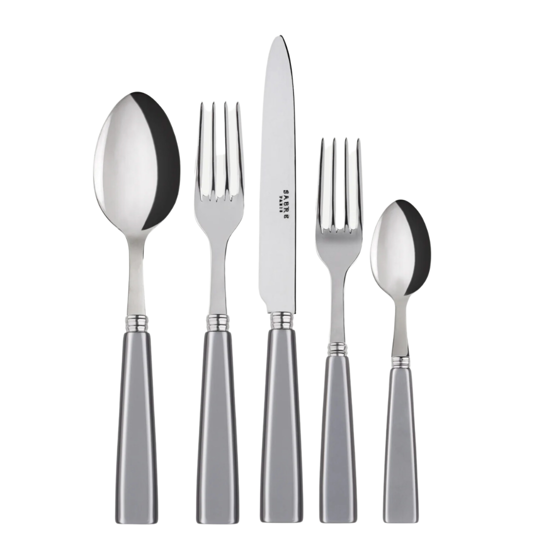 The Sabre Icone Flatware 5 Piece Setting includes a soup spoon, dinner fork, dinner knife, salad fork, and teaspoon with silver handles—crafted from 18/10 stainless steel and arranged side by side.