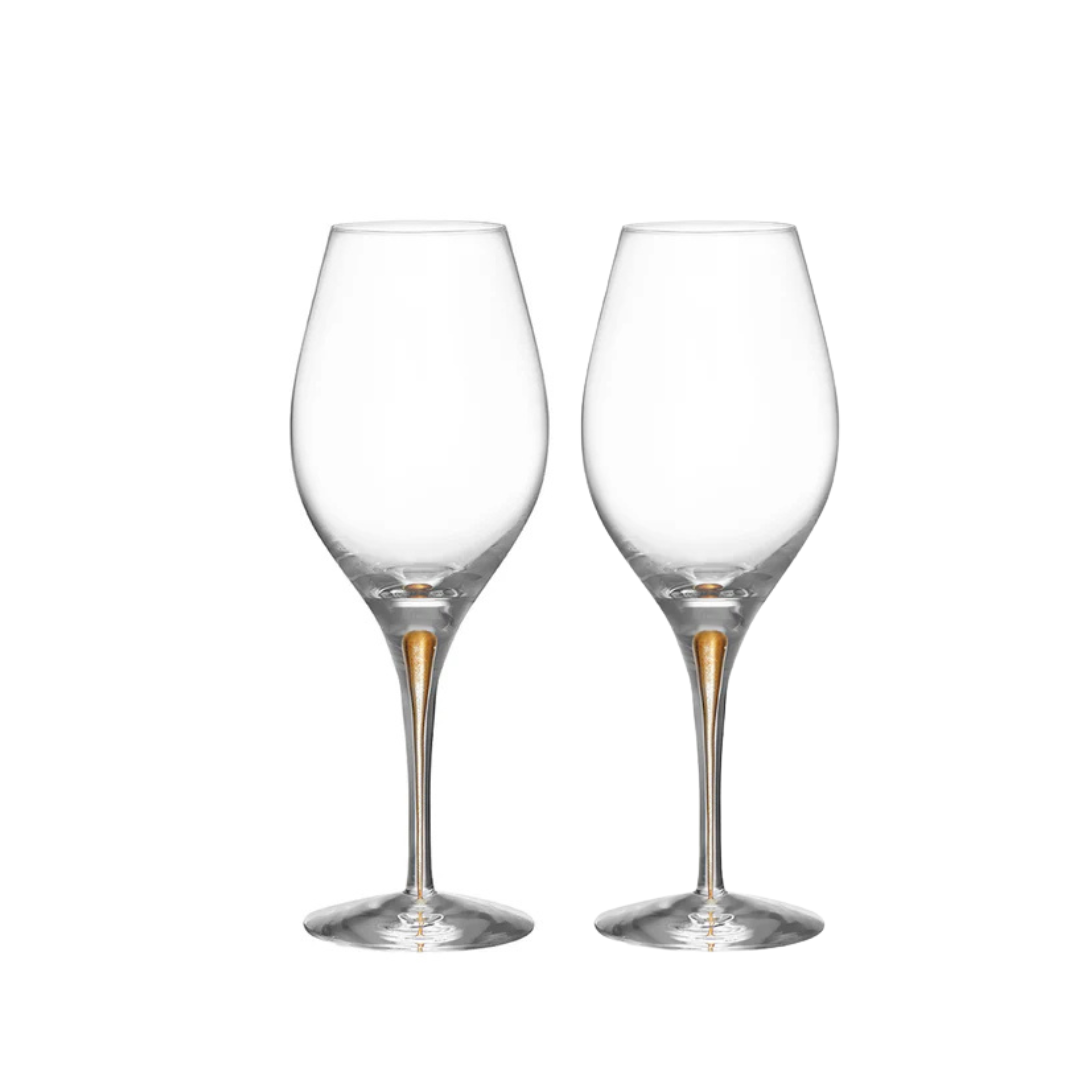 Two Orrefors Intermezzo Balance Wine Glasses Gold, set of 2, stand upright with long stems side by side on a plain white background.