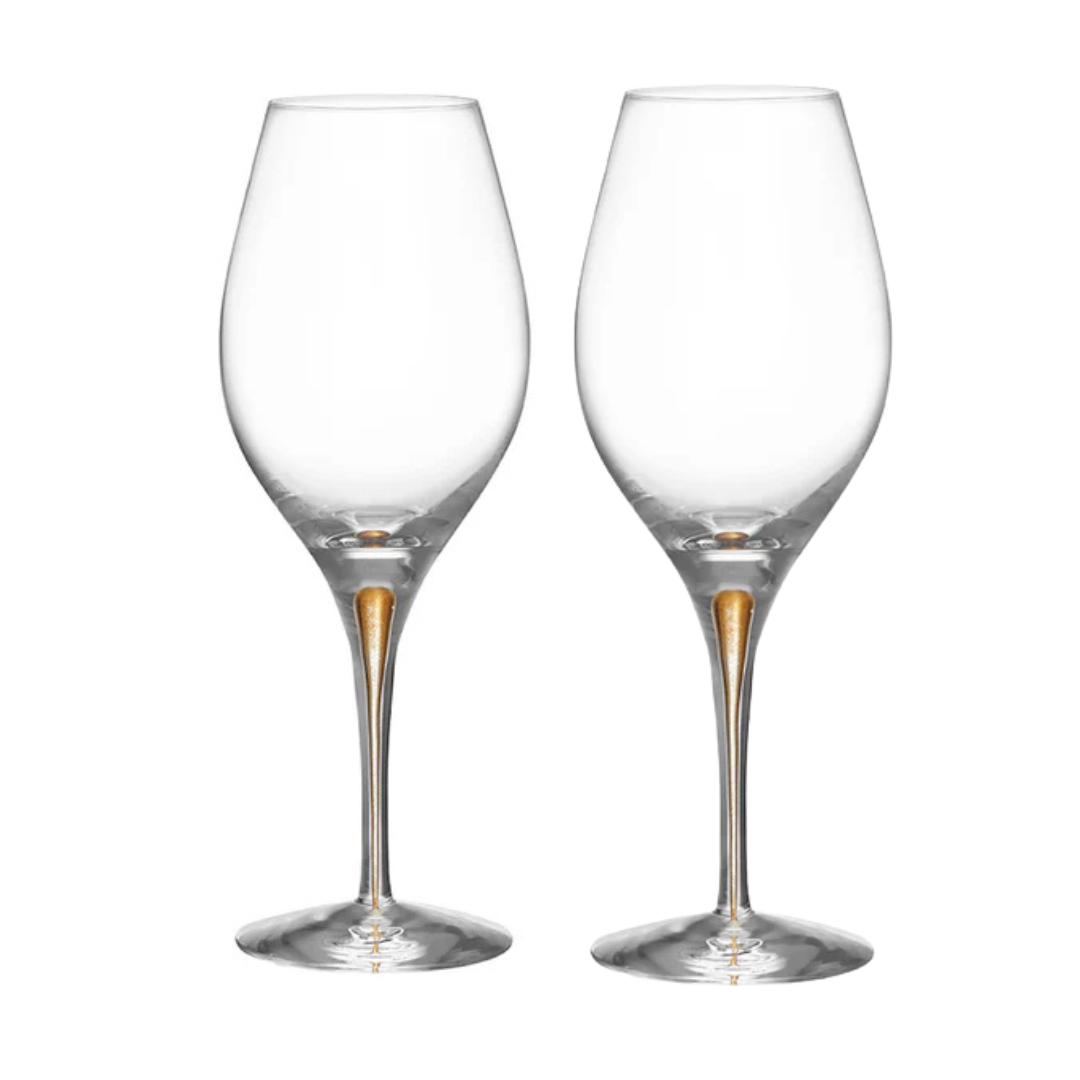 Two Orrefors Intermezzo Balance Wine Glass Gold, Set of 2, designed with slender stems and a subtle gold accent, stand side by side on a white background.