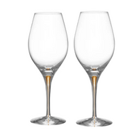 Two Orrefors Intermezzo Balance Wine Glass Gold, Set of 2, designed with slender stems and a subtle gold accent, stand side by side on a white background.