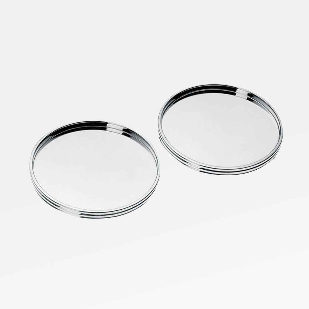 Two Christofle K+T Two Silver-Plated Coasters are displayed side by side on a plain white background.