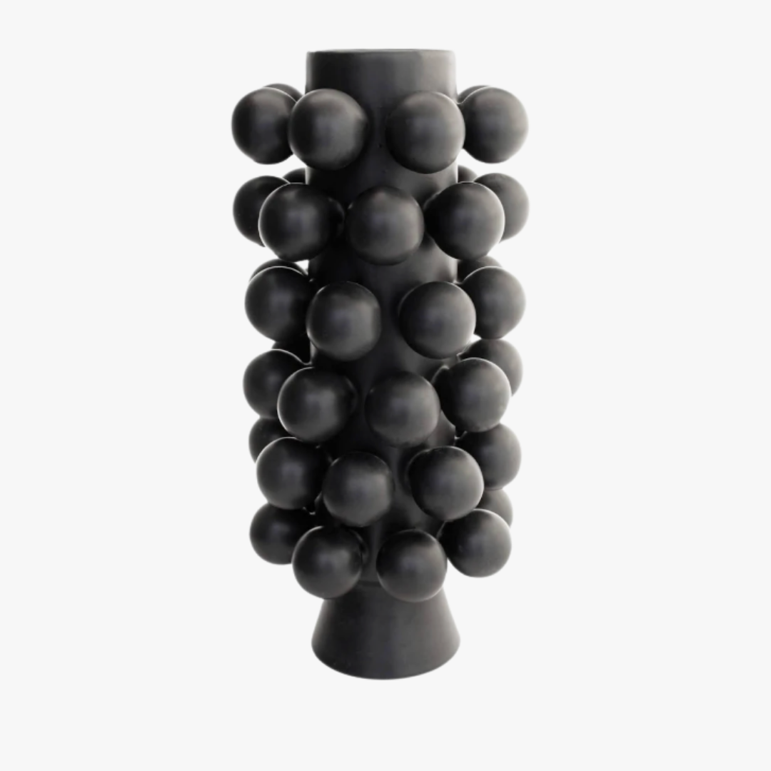 The Nimbus Tall Vase - Onyx by KleinReid is a tall, matte black porcelain vase featuring a cylindrical silhouette and adorned with evenly spaced, raised spherical bumps; expertly handcrafted in Brooklyn and photographed against a plain white background.