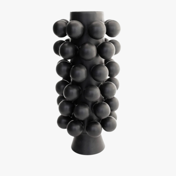 The Nimbus Tall Vase - Onyx by KleinReid is a tall, matte black porcelain vase featuring a cylindrical silhouette and adorned with evenly spaced, raised spherical bumps; expertly handcrafted in Brooklyn and photographed against a plain white background.