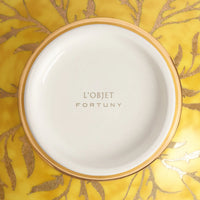 The L'Objet Fortuny Orfeo Serving Bowl Yellow - Medium features exquisite gold detailing and a gold-and-yellow coral-inspired pattern, making it an elegant earthenware centerpiece.