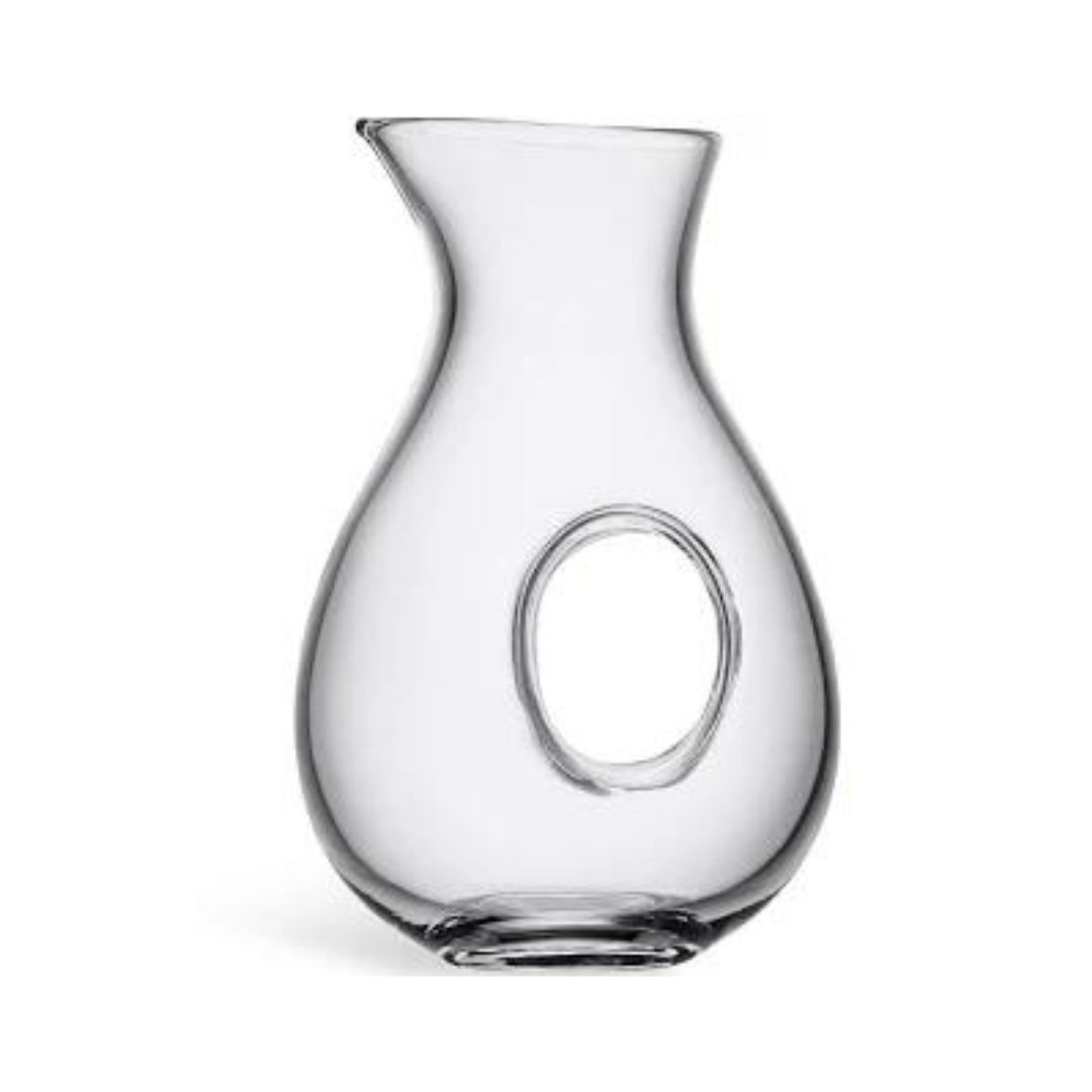 The LSA Ono Jug is a hand-blown glass pitcher with a wide base, narrow neck, and signature oval hole for easy grip. Its modern, elegant design features smooth lines that showcase expert craftsmanship.