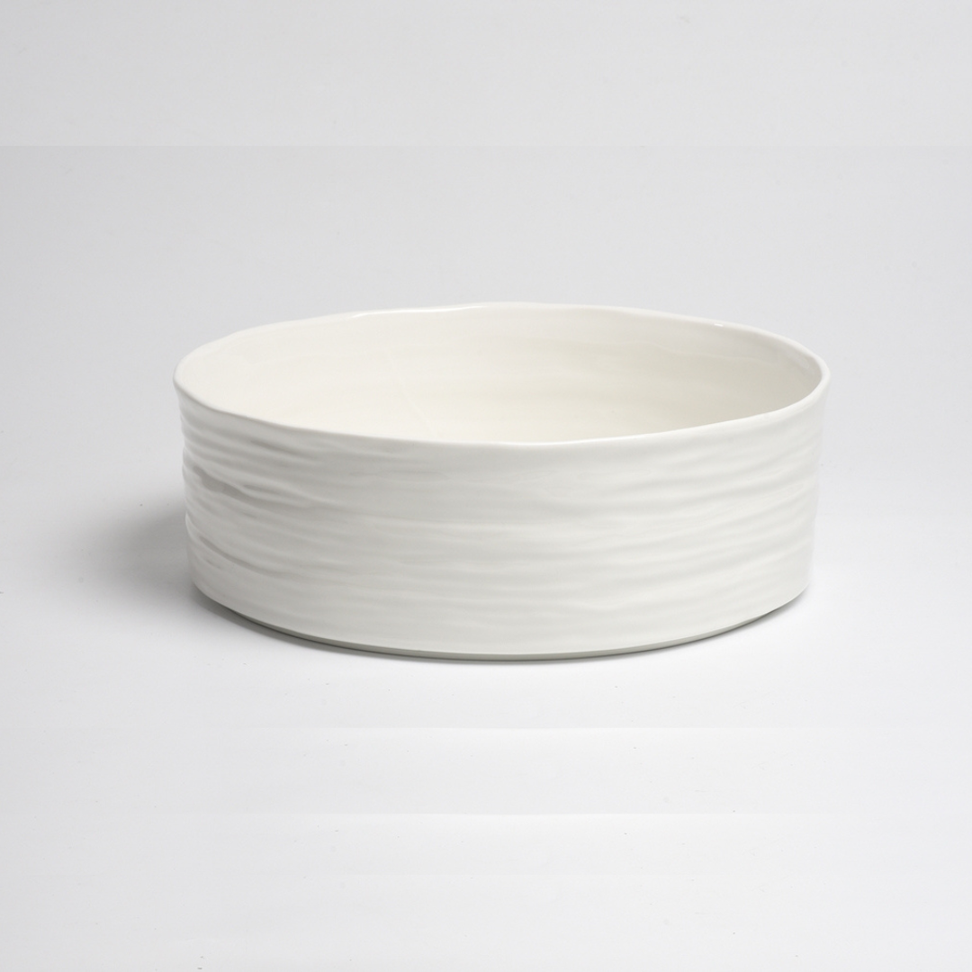 The Le Blanc Bowl by PAMPA BAY features a simple, wide design in white porcelain with a textured, ribbed exterior, shown on a white background.