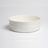 The Le Blanc Bowl by PAMPA BAY features a simple, wide design in white porcelain with a textured, ribbed exterior, shown on a white background.