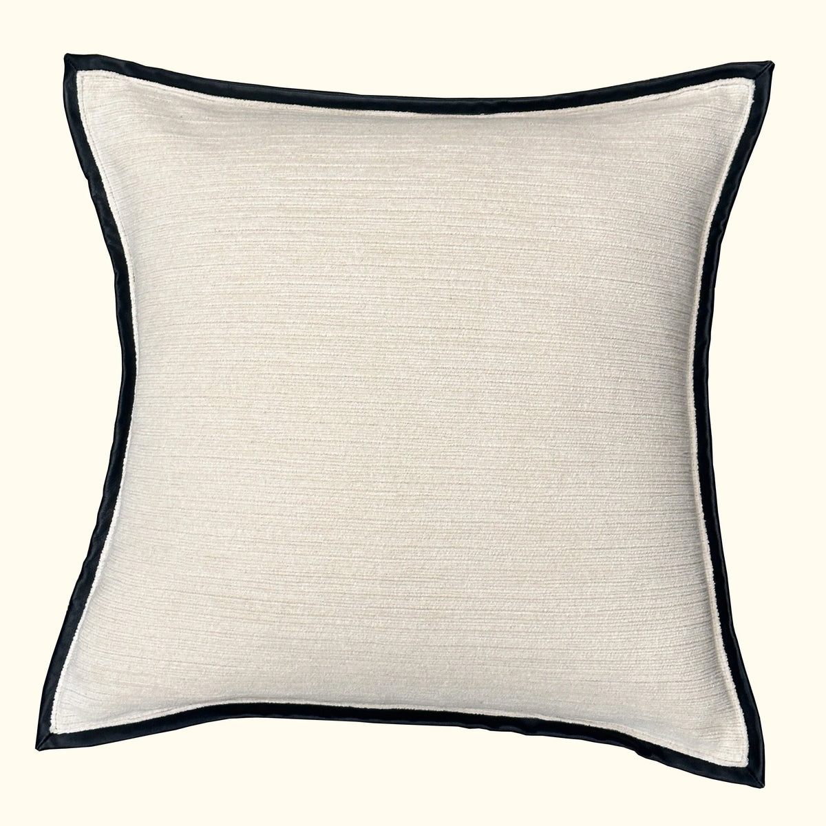 The Threads Soft Goods Leather Frame Pillow Ivory is a square, ivory accent pillow with a subtle texture and slim black leather border, shown against a plain off-white background.