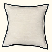 The Threads Soft Goods Leather Frame Pillow Ivory is a square, ivory accent pillow with a subtle texture and slim black leather border, shown against a plain off-white background.