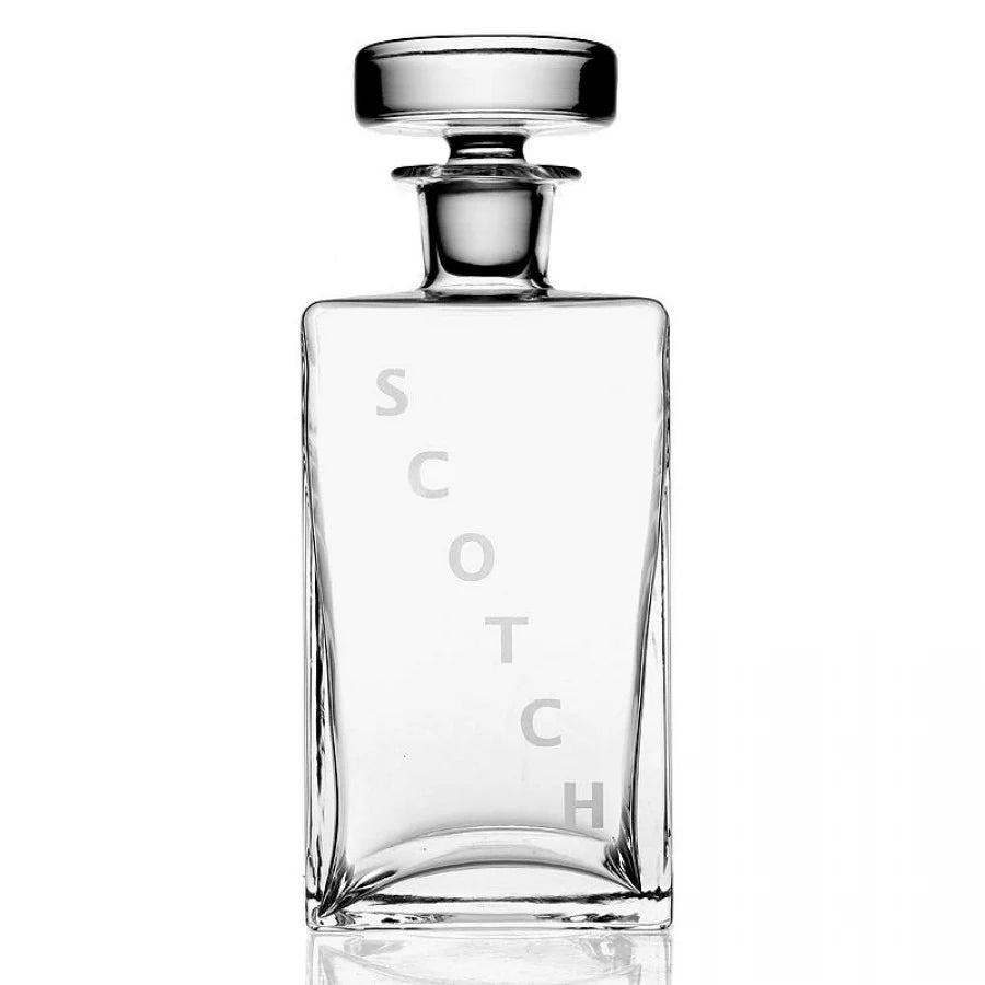 The William Yeoward Lillian Decanter Scotch is a clear, rectangular handmade crystal glass decanter with a round stopper and frosted vertical "SCOTCH" lettering, displayed empty on a white background.