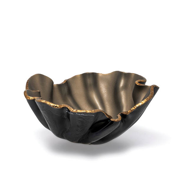 The Lirio R Matt Black & Bronze Bowl by Gardeco features a wavy, ruffled rim, matte black exterior, and metallic bronze interior with gold-trimmed edge—crafted by Brazilian artist Regina Medeiros and shown against a white background.
