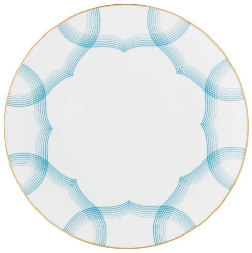 The Aura Dinnerware by Raynaud is a round white plate with a thin gold rim, made in France, featuring overlapping blue curved lines in a symmetrical geometric design near the edges.