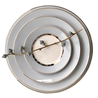 Four stacked Recamier MAK Grey & Platinum plates by Royal Limoges/Bia Cordon Bleu are arranged from largest to smallest, with a delicate branch bearing small buds placed diagonally across this elegant dinnerware set.