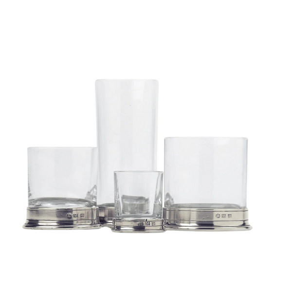 Four MATCH Pewter Barware glass tumblers by MATCH, each with silver Italian pewter bases and varying heights, are arranged side by side on a white background.