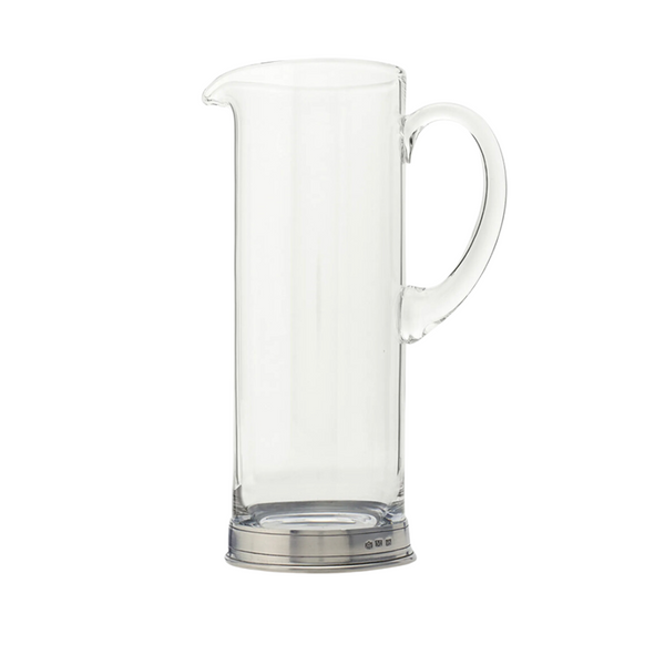 The MATCH Martini Crystal Pitcher by MATCH features a clear glass design with a curved handle, pouring spout, and a shiny handmade pewter base crafted by Italian artisans, shown against a white background.