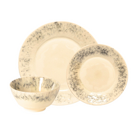 The Costa Nova Madeira Dinnerware Cream set includes a large plate, a smaller plate, and a bowl, all handcrafted in Portugal with cream stoneware and speckled gray and black rims.