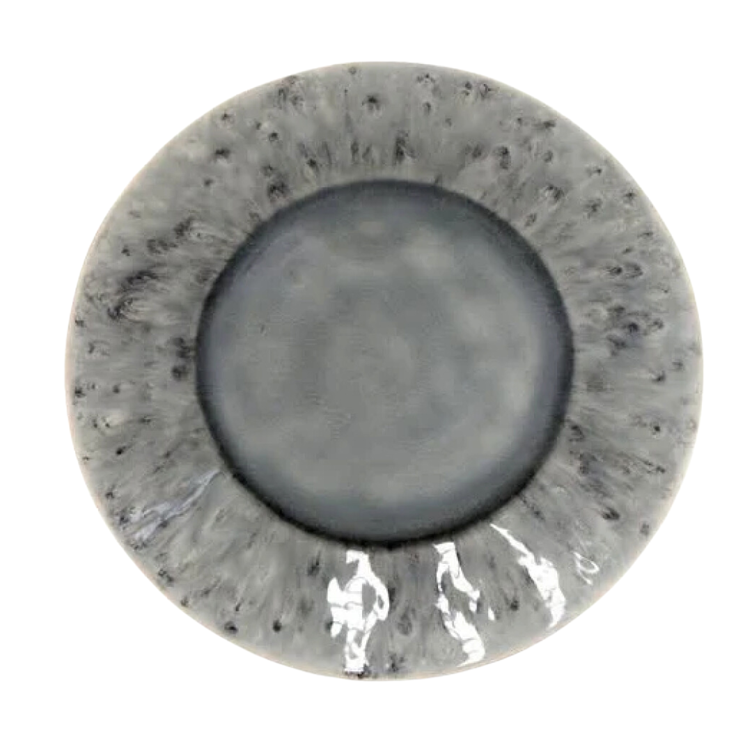 The Costa Nova Madeira Grey Dinnerware is a round handcrafted stoneware plate with a marbled gray and black design, darker center, lighter speckled edges, and a glossy finish that highlights its artisanal quality. Made in Portugal.
