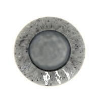 The Madeira Grey Dinnerware by Costa Nova features a round handcrafted stoneware plate with a gray and black marbled pattern, lighter speckled rim, and glossy solid gray center. Expertly crafted in Portugal for timeless appeal.