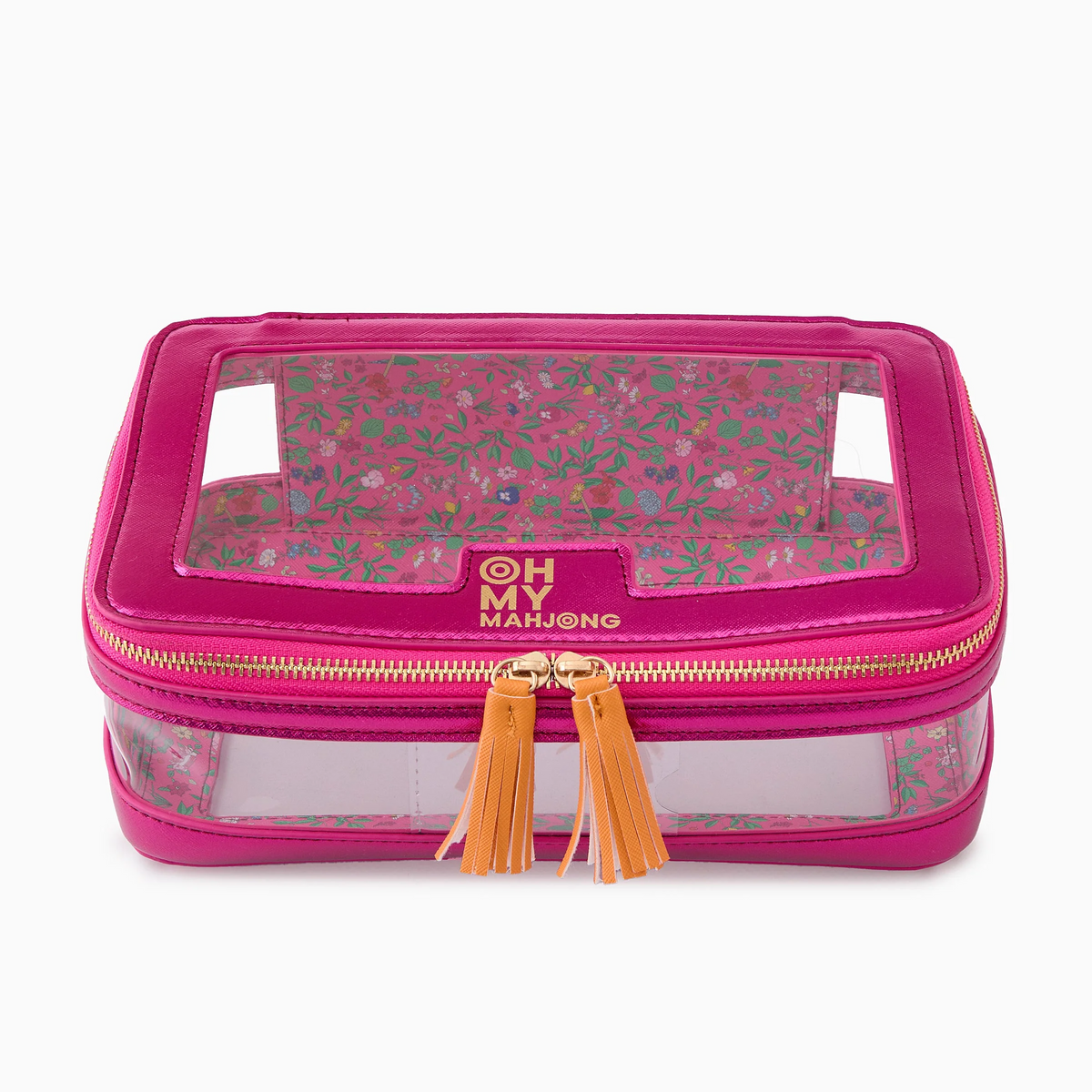 A pink rectangular Mahjong Tile Storage Bag by Oh My Mahjong, featuring clear sides and top, gold zipper pulls with yellow tassels, and a floral patterned interior. “Oh My Mahjong” is printed in gold on the front, making this bag both a stylish tile storage solution and a chic Mahjong organizer.