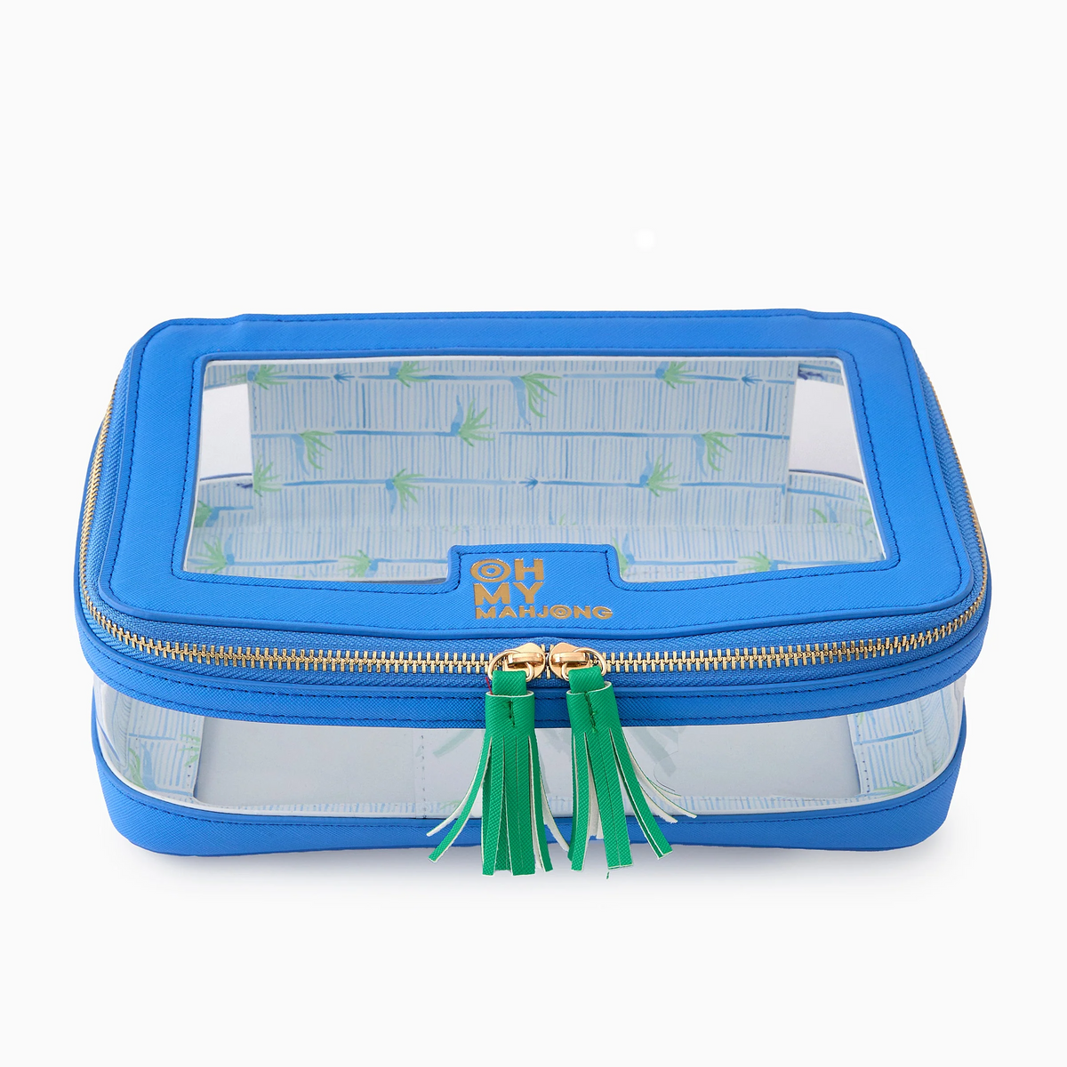 Introducing the Mahjong Tile Storage Bag by Oh My Mahjong—a blue Mahjong organizer featuring clear plastic sides and top, accented with gold zippers and green tassels. The front displays “OH MY MAHJONG” in gold lettering. Inside, you’ll find a chic blue-and-white striped lining, making it ideal for stylish and organized storage of your mahjong tiles.