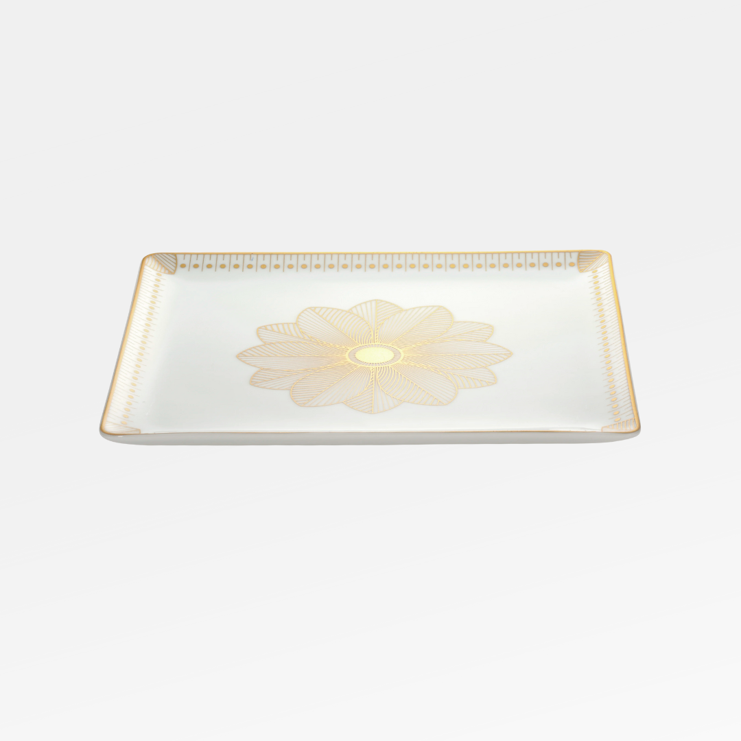 The Christofle Malmaison Porcelain Catchall Tray features an intricate gold floral centerpiece and a geometric gold rim, showcasing elegant Malmaison Impériale style against a classic white background.