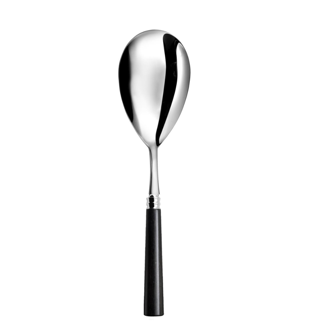 A large Capdeco Marat Wood Flatware serving spoon with a reflective oval bowl and wood handle, displayed upright against a white background—a modern twist on classic French cutlery.