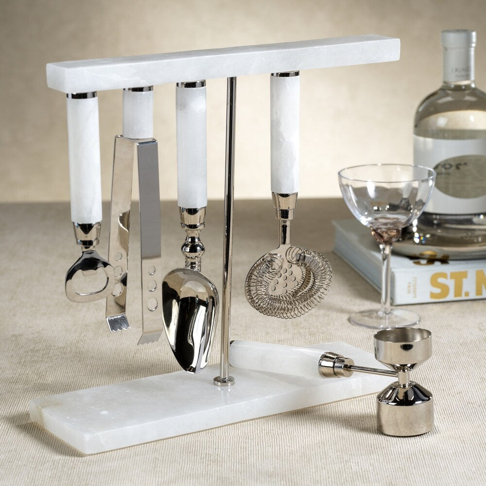 The Zodax Alabaster White Bar Tool Set—featuring a bottle opener, ice tongs, scoop, strainer, and jigger—adds style and function to your tabletop for elevated cocktails.