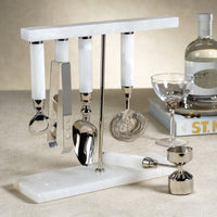 The Zodax Alabaster White Bar Tool Set—featuring a bottle opener, ice tongs, scoop, strainer, and jigger—adds style and function to your tabletop for elevated cocktails.
