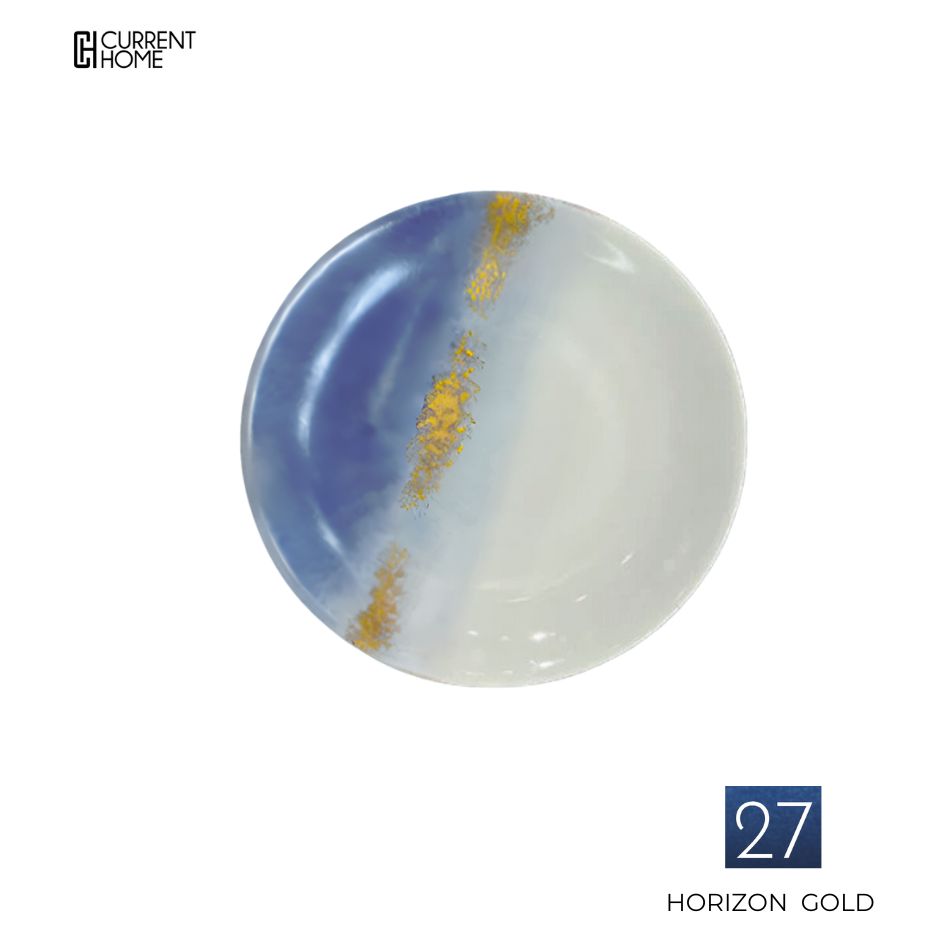 The Marie Daâge Horizon Gold Dinnerware plate features a blue and white gradient with a hand-painted gold streak, style number 27, from the brand Marie Daâge. The Current Home logo appears in the top left corner.