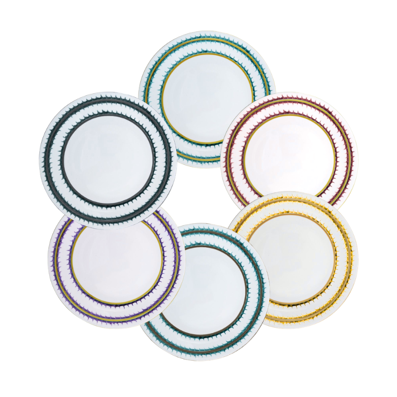 Six Marie Daâge Rafia Stripes plates, crafted from Limoges porcelain, each with a unique colored rim—green, teal, red, black, purple, and gold—feature intricate gold and colored patterns for luxurious table settings.
