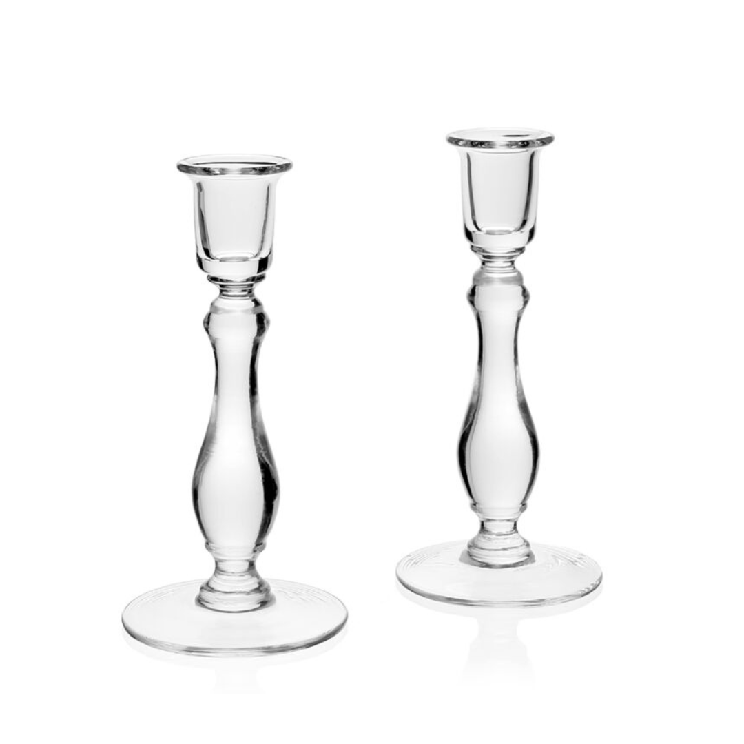 The William Yeoward Meryl Candlesticks Set of 2 features clear crystal holders with curved stems and round bases, standing upright on a white background—an elegant décor addition to any room.
