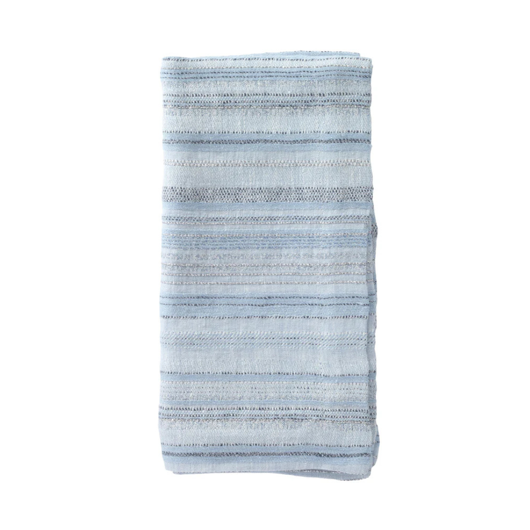 The Midas Napkin Set of 4 by Bodrum features folded light blue fabric with horizontal stripes of varying thickness, accented by silver metallic threads—ideal for adding elegance to any table setting.