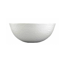 A white, textured ceramic bowl from Raynaud's Mineral Dinnerware Glazed White collection, inspired by French design, photographed on a white background.